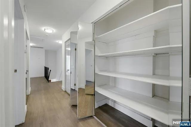 a view of a hallway with seating space