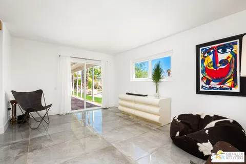a living room with furniture and a book shelf