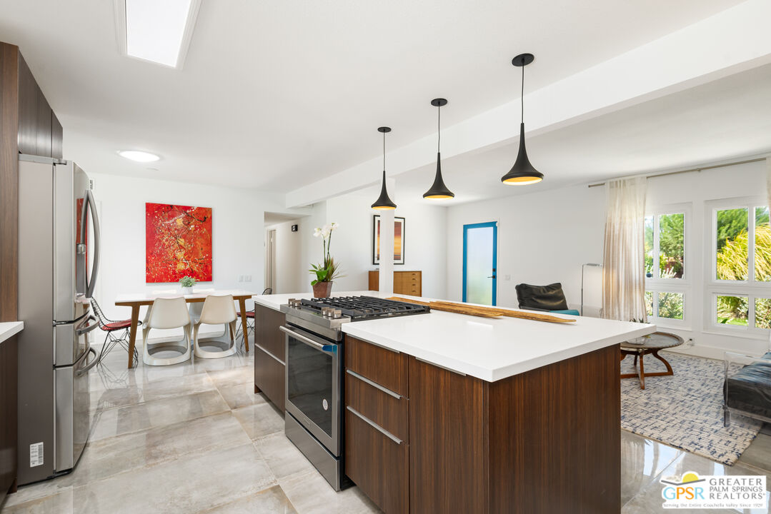 2405 East Francis Drive Palm Springs, CA 92262 - Photo 6 of 17 a kitchen that has a sink a stove and a table with chairs
