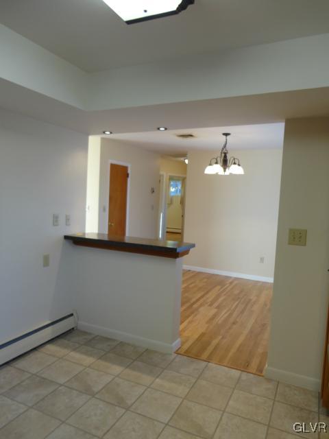 1230 Clearfield Road Nazareth, PA 18064 - Photo 14 of 20 a view of a hallway with wooden floor and chandelier