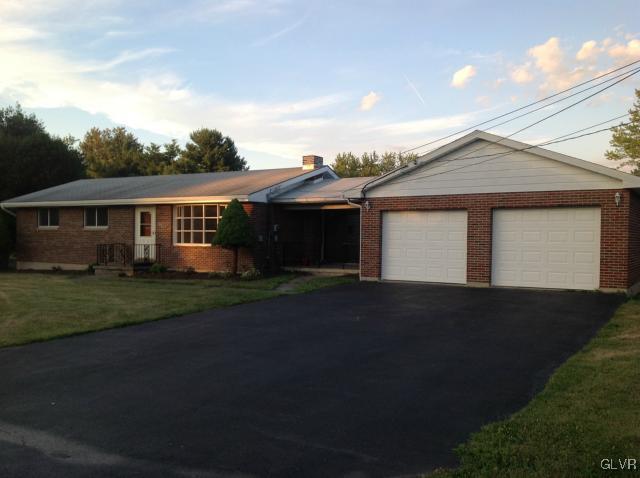 1230 Clearfield Road Nazareth, PA 18064 - Photo 3 of 20 a front view of a house with a yard and garage
