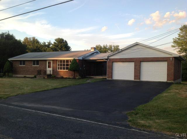 1230 Clearfield Road Nazareth, PA 18064 - Photo 6 of 20 a front view of a house with a yard and garage