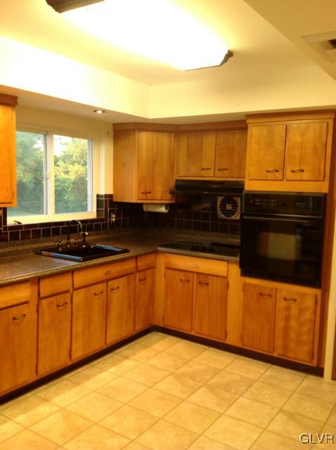1230 Clearfield Road Nazareth, PA 18064 - Photo 9 of 20 a kitchen with stainless steel appliances granite countertop a sink and cabinets