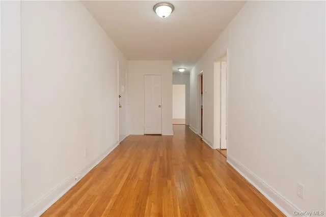 a view of a room with wooden floor