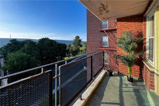 a view of balcony with wooden floor and fence