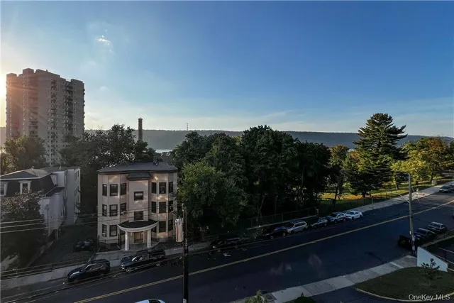 a view of a balcony with chairs and potted plants
