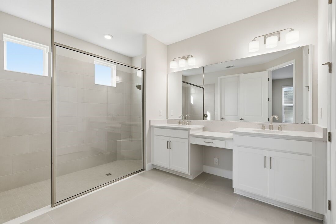 86654 Swift Launch Path Yulee, FL 32097 - Photo 13 of 31 a bathroom with a shower tub double vanity and a sink