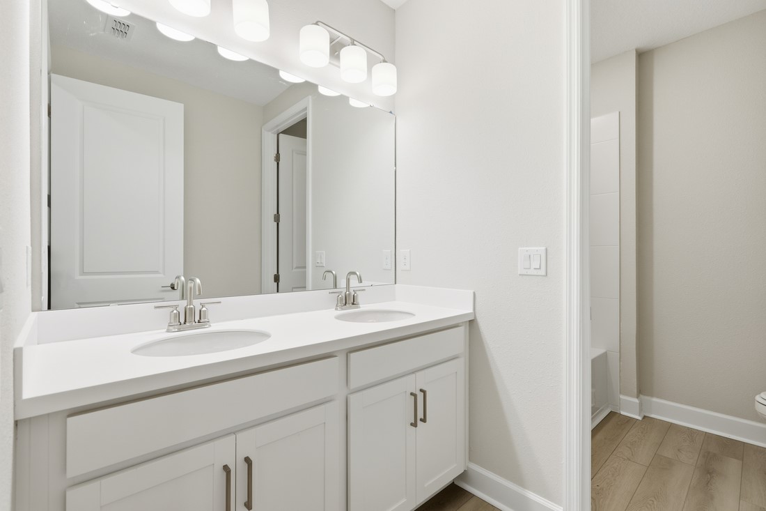86654 Swift Launch Path Yulee, FL 32097 - Photo 14 of 31 a bathroom with a sink a mirror and a light fixture