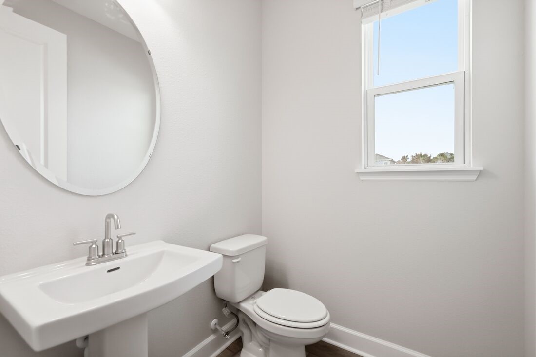 86654 Swift Launch Path Yulee, FL 32097 - Photo 20 of 31 a bathroom with a toilet a sink and mirror