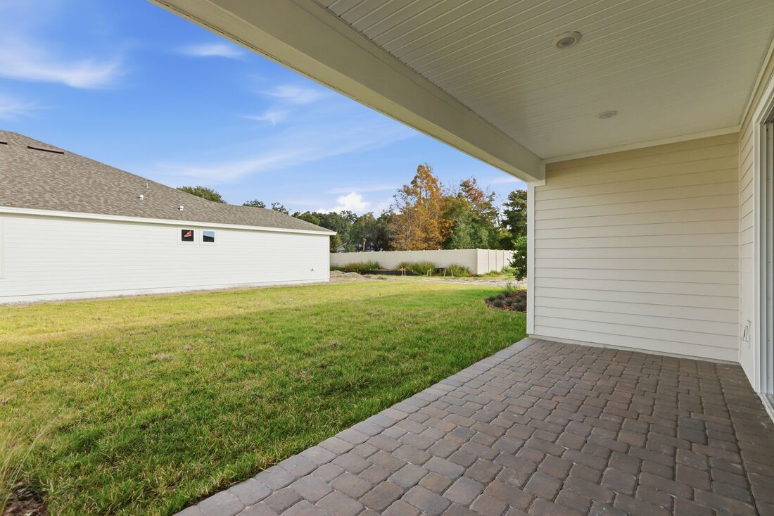 86654 Swift Launch Path Yulee, FL 32097 - Photo 25 of 31 a view of a big room with wooden floor and a yard