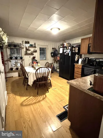 a dining room with furniture and a kitchen view