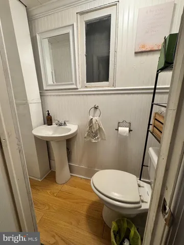 a white toilet sitting next to a bathroom sink