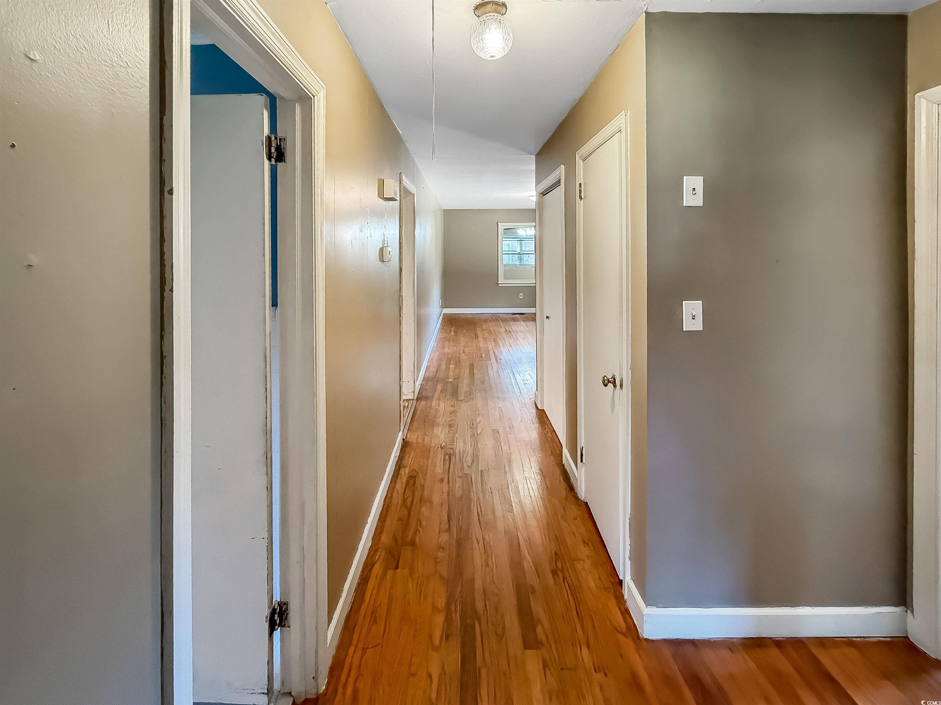 1682 Pickens Street Georgetown, SC 29440 - Photo 21 of 39 Hallway with light wood finished floors and baseboards