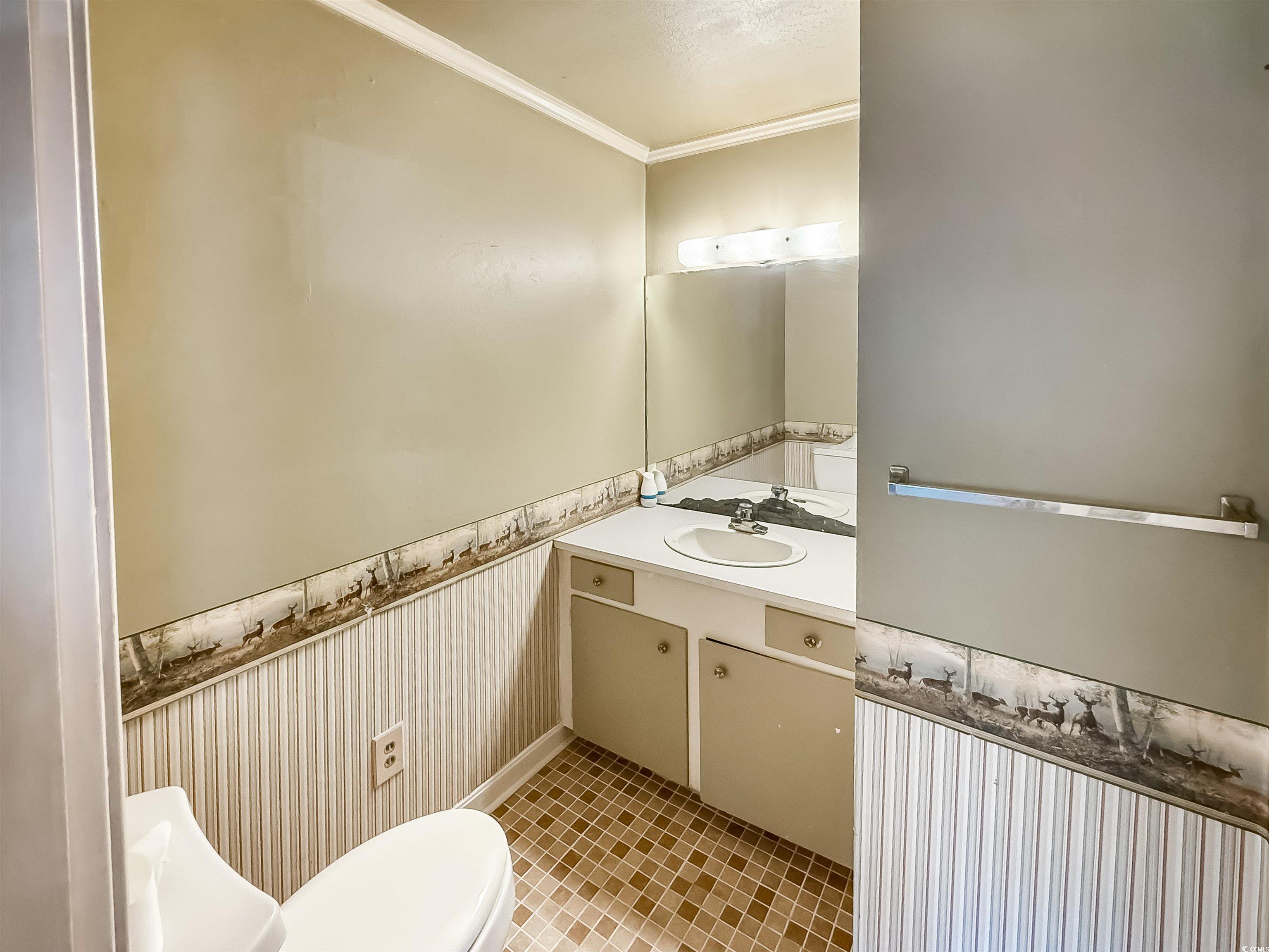 1682 Pickens Street Georgetown, SC 29440 - Photo 31 of 39 Bathroom with a wainscoted wall, crown molding, and vanity