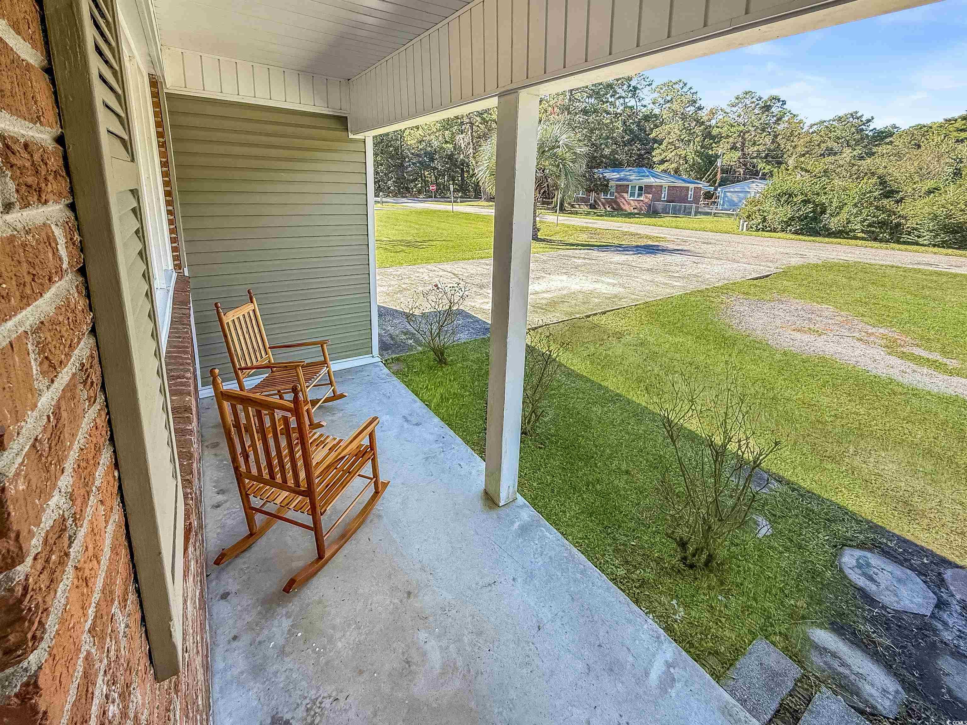 Covered porch with a yard