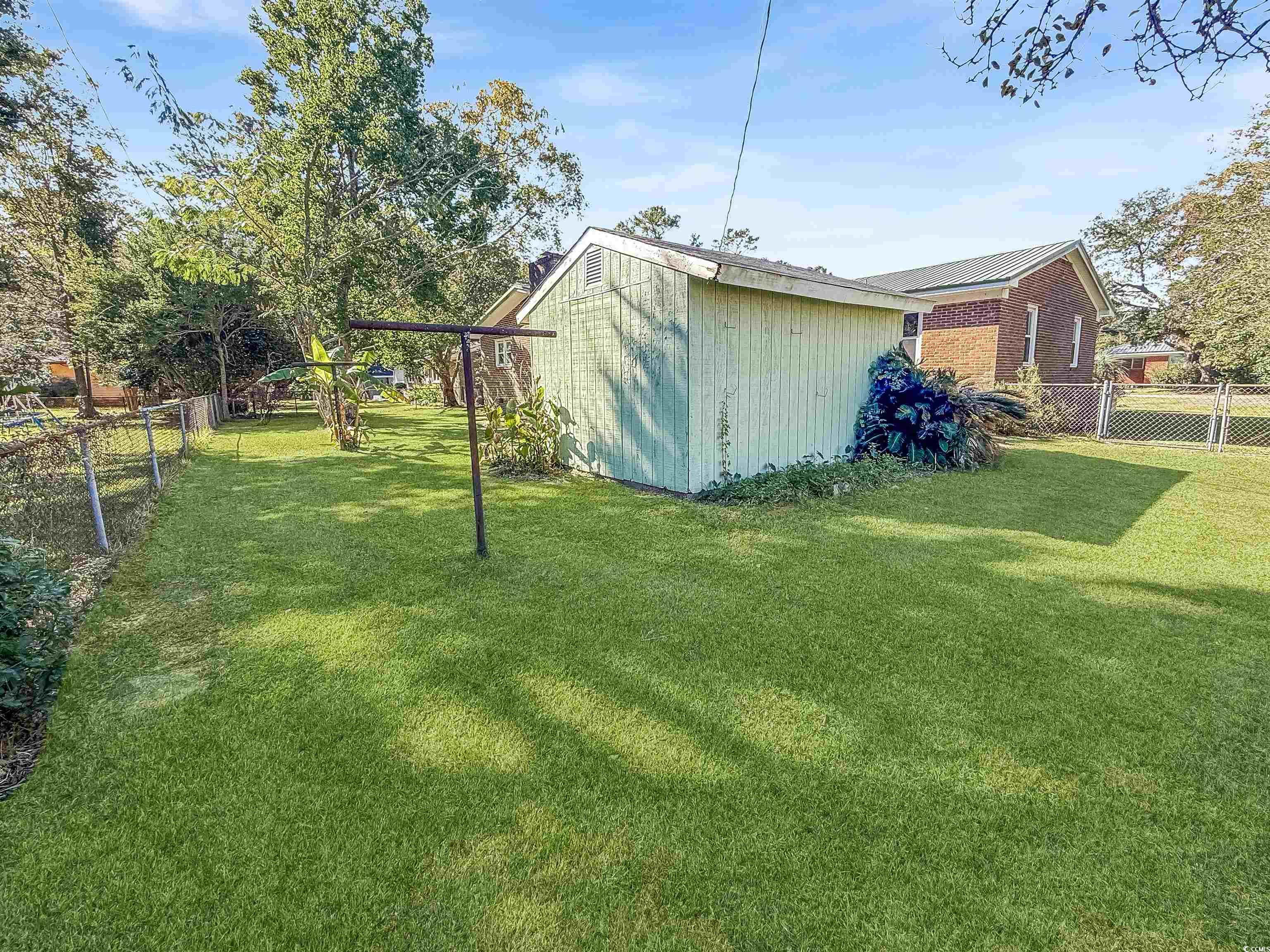 1682 Pickens Street Georgetown, SC 29440 - Photo 8 of 39 Fenced backyard featuring a shed