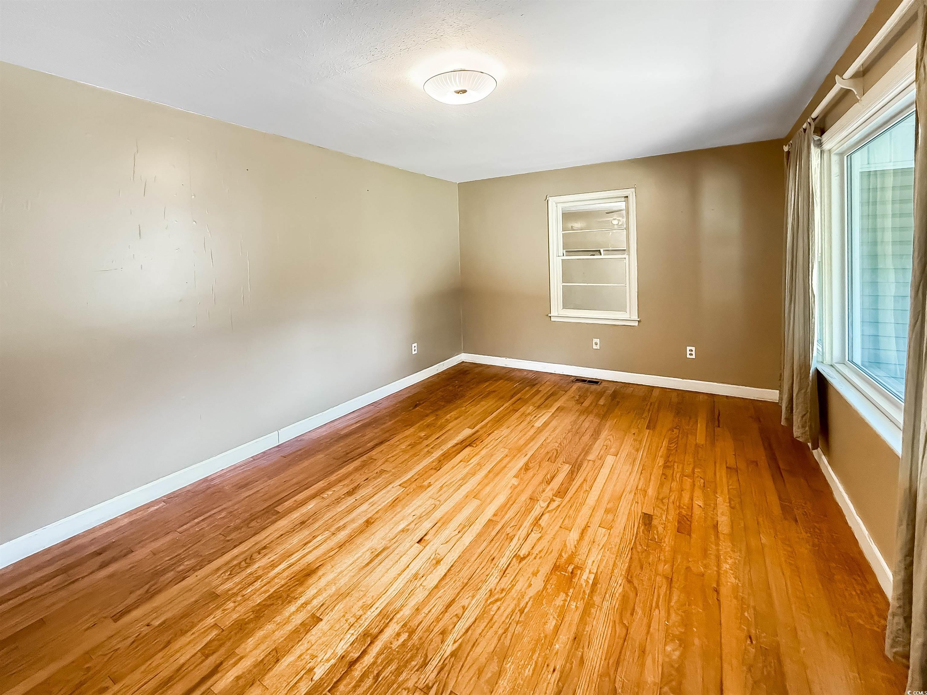1682 Pickens Street Georgetown, SC 29440 - Photo 10 of 39 Unfurnished room with baseboards and light wood-style floors