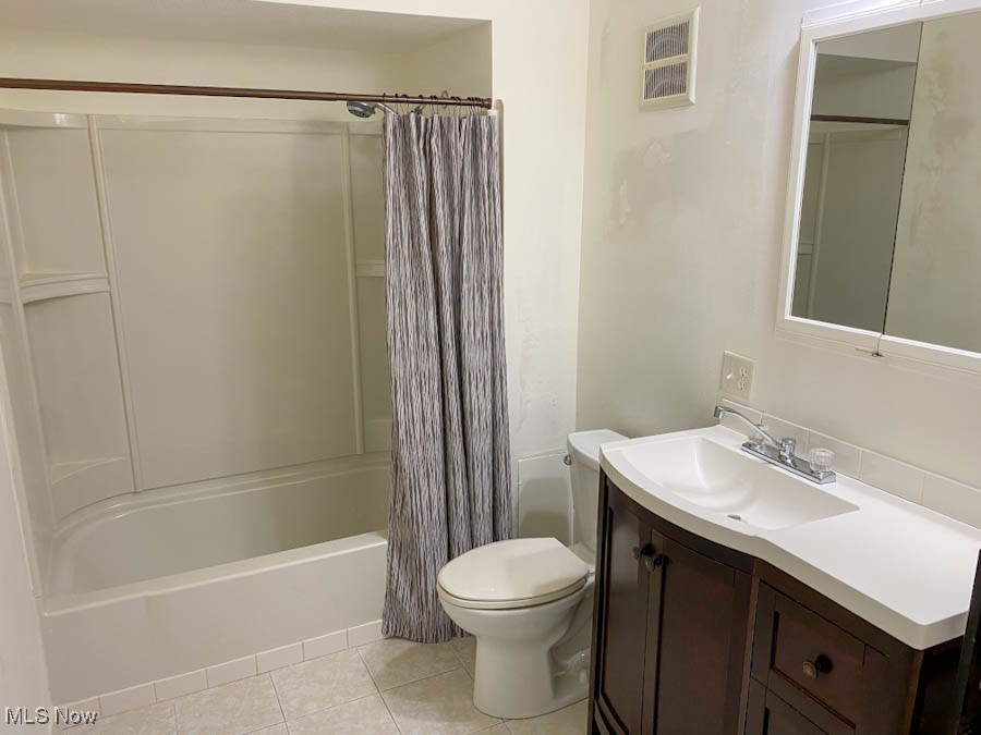 751 Garrison Road Ashtabula, OH 44004 - Photo 11 of 19 Bathroom featuring tile patterned floors, shower / bath combo with shower curtain, toilet, and vanity