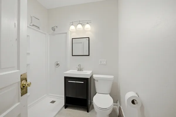 a view of a hallway with a bathroom
