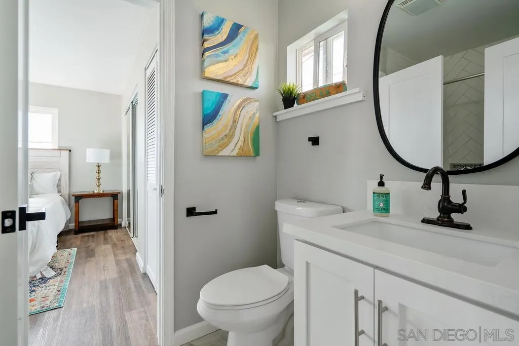 808 Leonard Avenue Oceanside, CA 92054 - Photo 21 of 25 a bathroom with a toilet sink and mirror