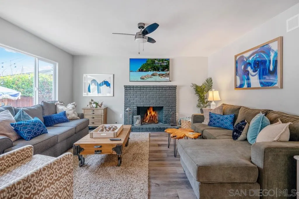 808 Leonard Avenue Oceanside, CA 92054 - Photo 6 of 25 a living room with furniture a clock and a fireplace