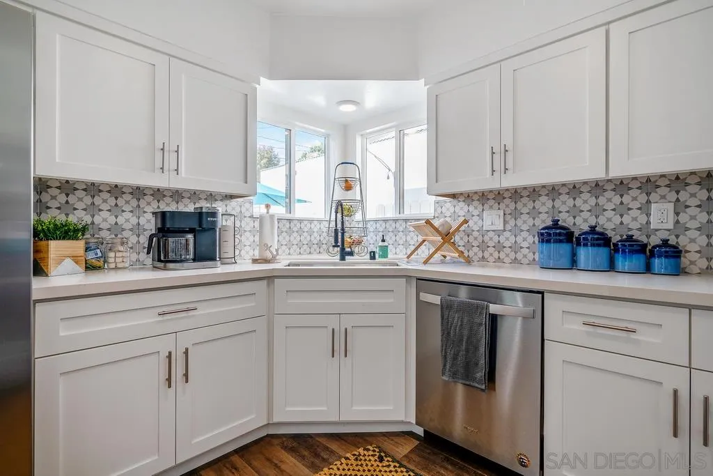 808 Leonard Avenue Oceanside, CA 92054 - Photo 7 of 25 a kitchen with white cabinets and white appliances