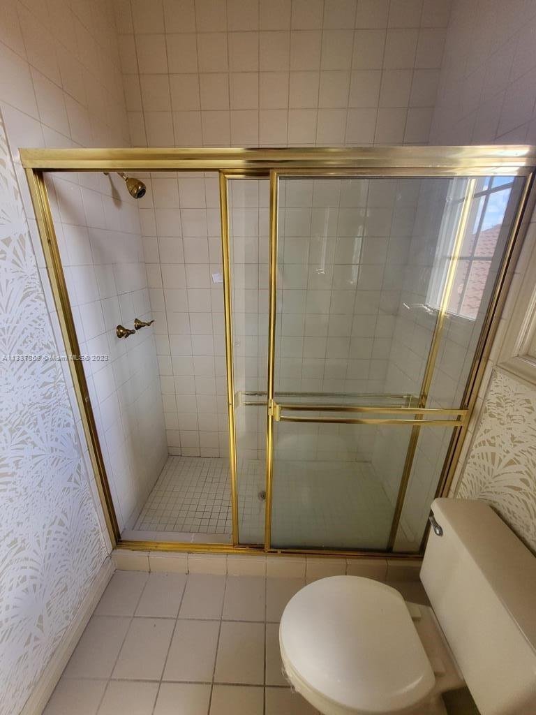 21249 Harrow Court Boca Raton, FL 33433 - Photo 13 of 18 a bathroom with a toilet and a shower
