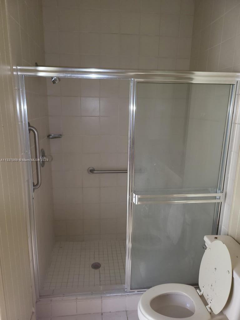 21249 Harrow Court Boca Raton, FL 33433 - Photo 18 of 18 a bathroom with a shower and toilet