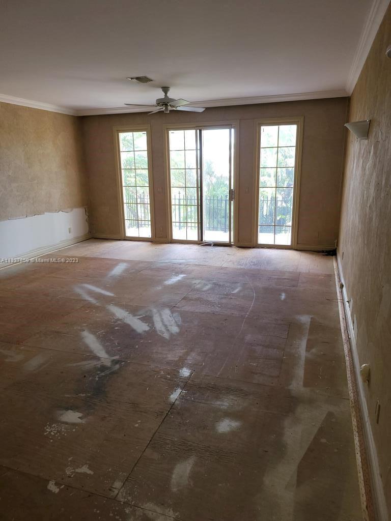 21249 Harrow Court Boca Raton, FL 33433 - Photo 10 of 18 a view of an empty room with a fireplace and large windows