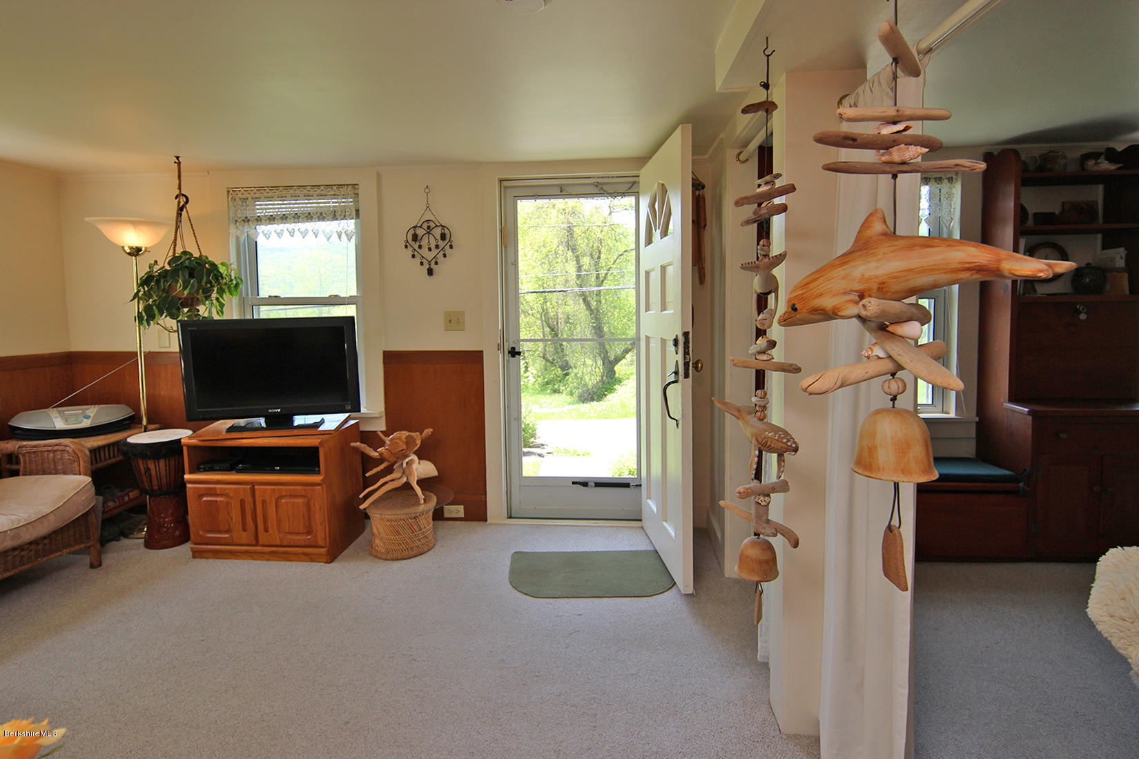 49 Main Road Tyringham, MA 01238 - Photo 8 of 32 a living room with furniture a window and a flat screen tv