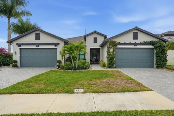 a view of front of house with a yard and garage