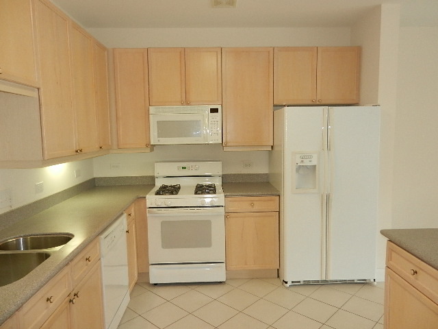 620 McHenry Road, Unit 303 Wheeling, IL 60090 - Photo 5 of 18 a view of a kitchen with white cabinets
