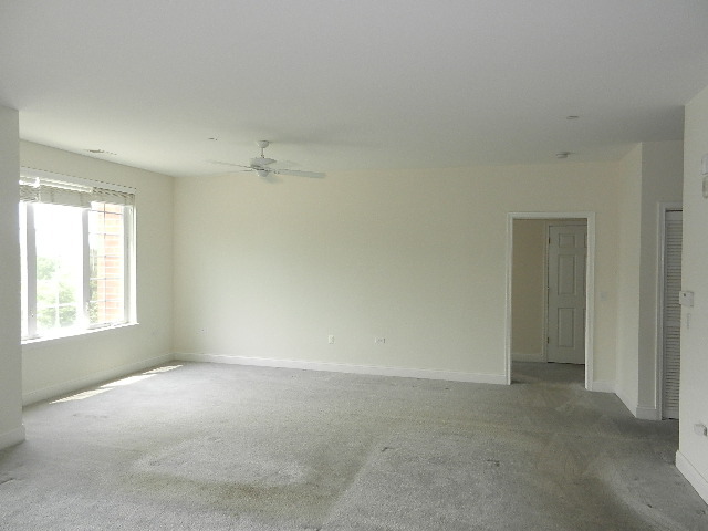 620 McHenry Road, Unit 303 Wheeling, IL 60090 - Photo 7 of 18 an empty room with a window