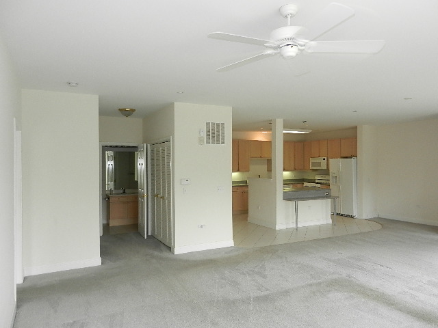620 McHenry Road, Unit 303 Wheeling, IL 60090 - Photo 9 of 18 a view of a kitchen with a sink and a refrigerator