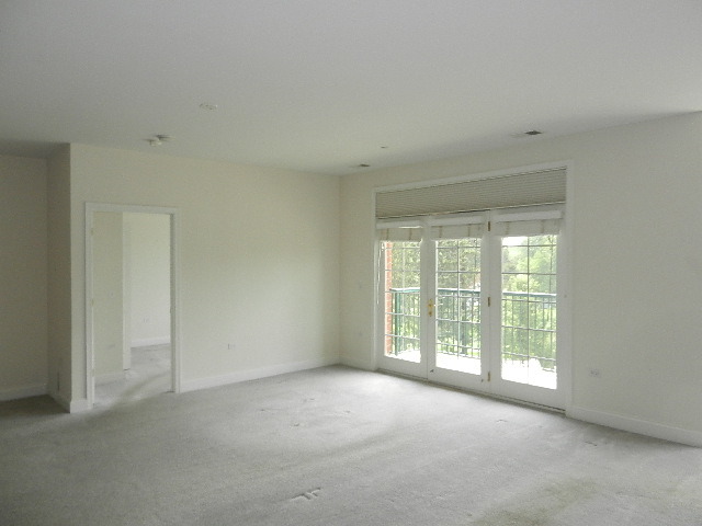 620 McHenry Road, Unit 303 Wheeling, IL 60090 - Photo 10 of 18 a view of an empty room with a window