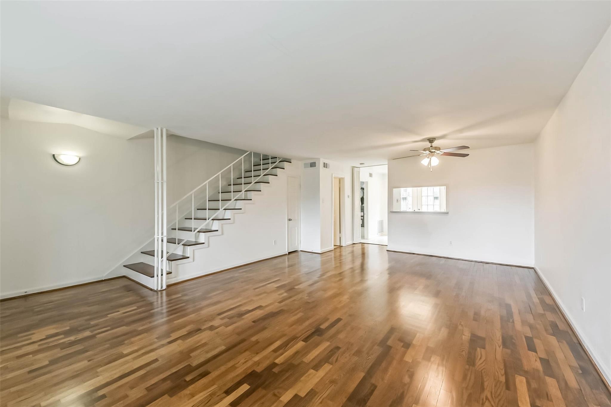 815 South Ripple Creek Drive, Unit 4 Houston, TX 77057 - Photo 3 of 12 an empty room with wooden floor and windows