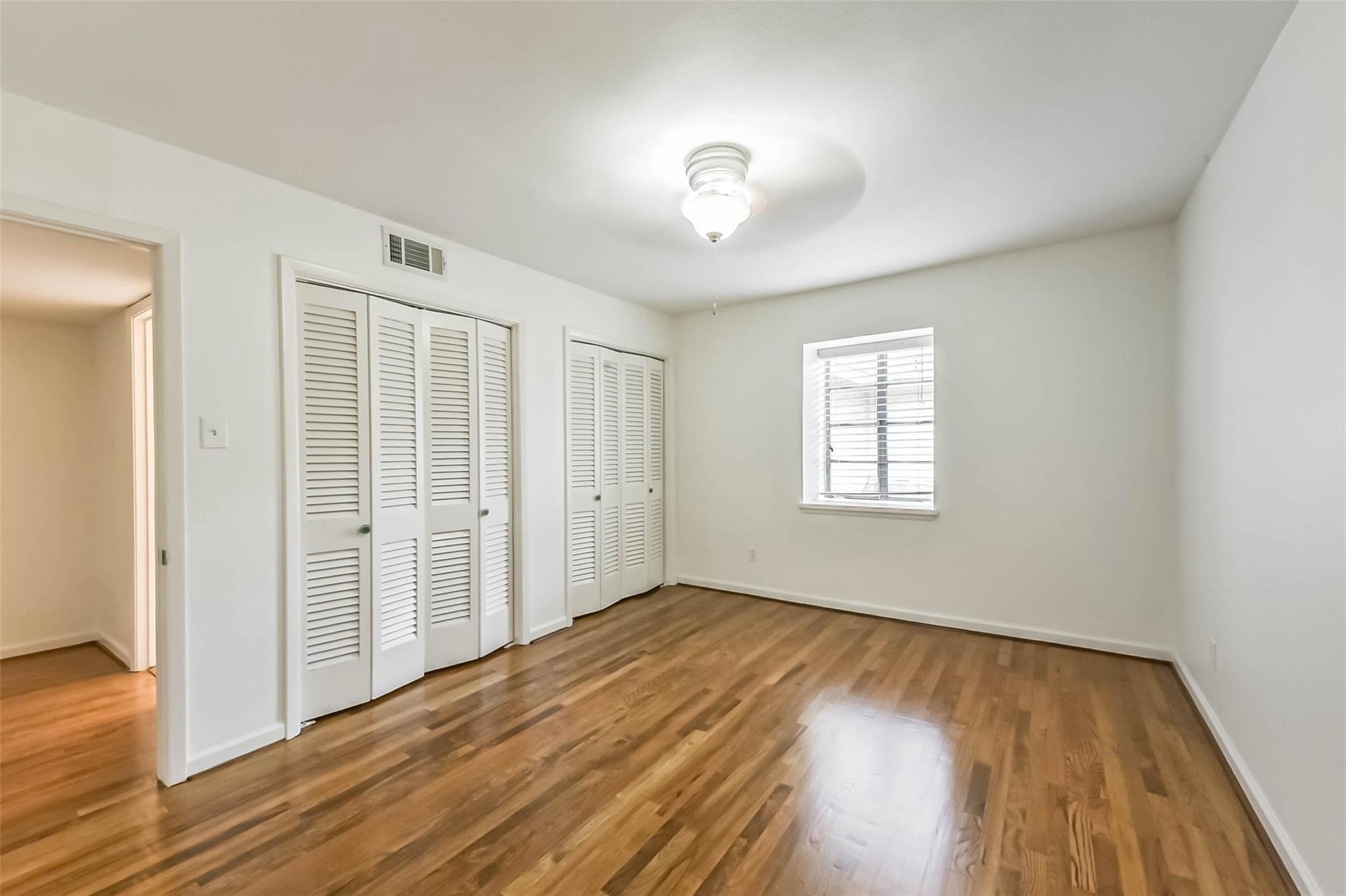 815 South Ripple Creek Drive, Unit 4 Houston, TX 77057 - Photo 8 of 12 wooden floor in an empty room with a window