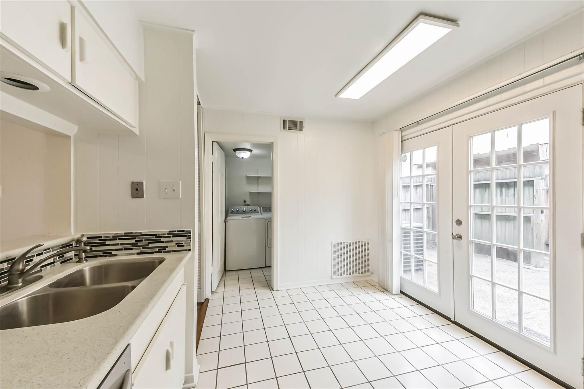 815 South Ripple Creek Drive, Unit 4 Houston, TX 77057 - Photo 10 of 12 a kitchen with a sink and refrigerator