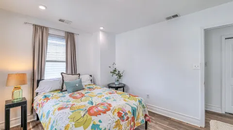 a bedroom with a bed and a window