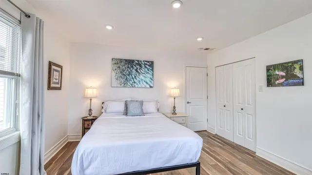 a bedroom with a large bed and a chandelier