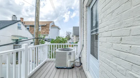 a view of balcony with wooden floor and fence