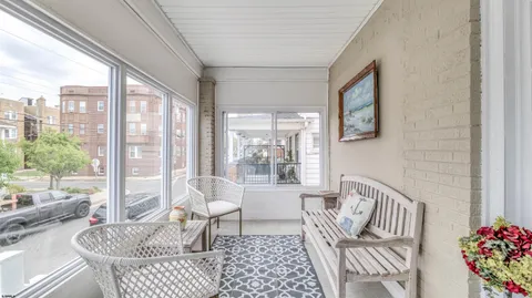 a living room with furniture and a floor to ceiling window