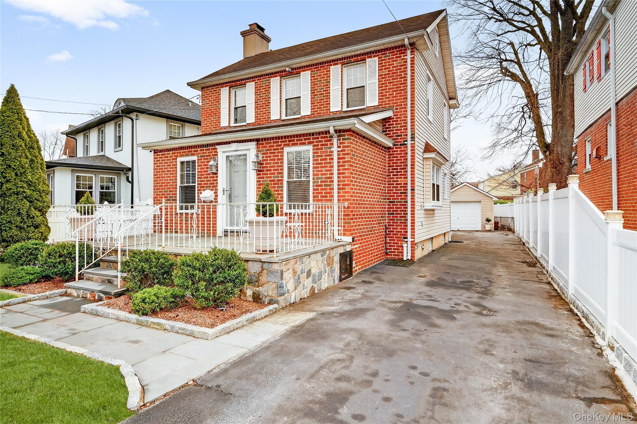 3334 Country Club Road Bronx, NY 10465 - Photo 3 of 49 View of front facade with an outbuilding, a chimney, brick siding, and a garage