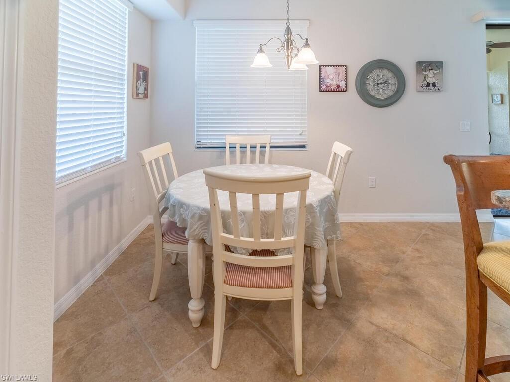 9115 Napoli Court, Unit 101 Naples, FL 34113 - Photo 11 of 49 a dining room with furniture and a window
