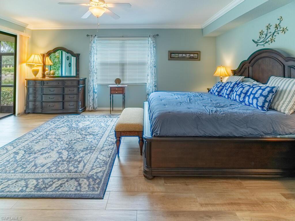 9115 Napoli Court, Unit 101 Naples, FL 34113 - Photo 13 of 49 a bedroom with a bed and window