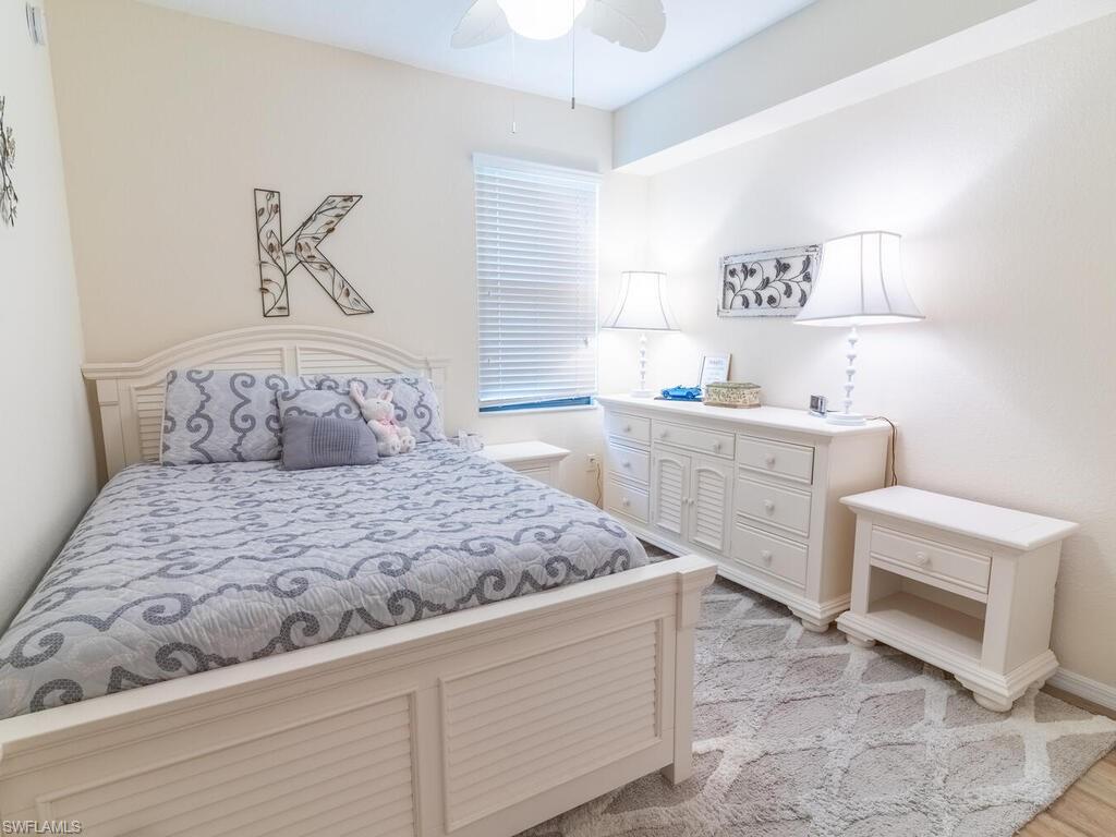 9115 Napoli Court, Unit 101 Naples, FL 34113 - Photo 17 of 49 a bedroom with a bed and a window