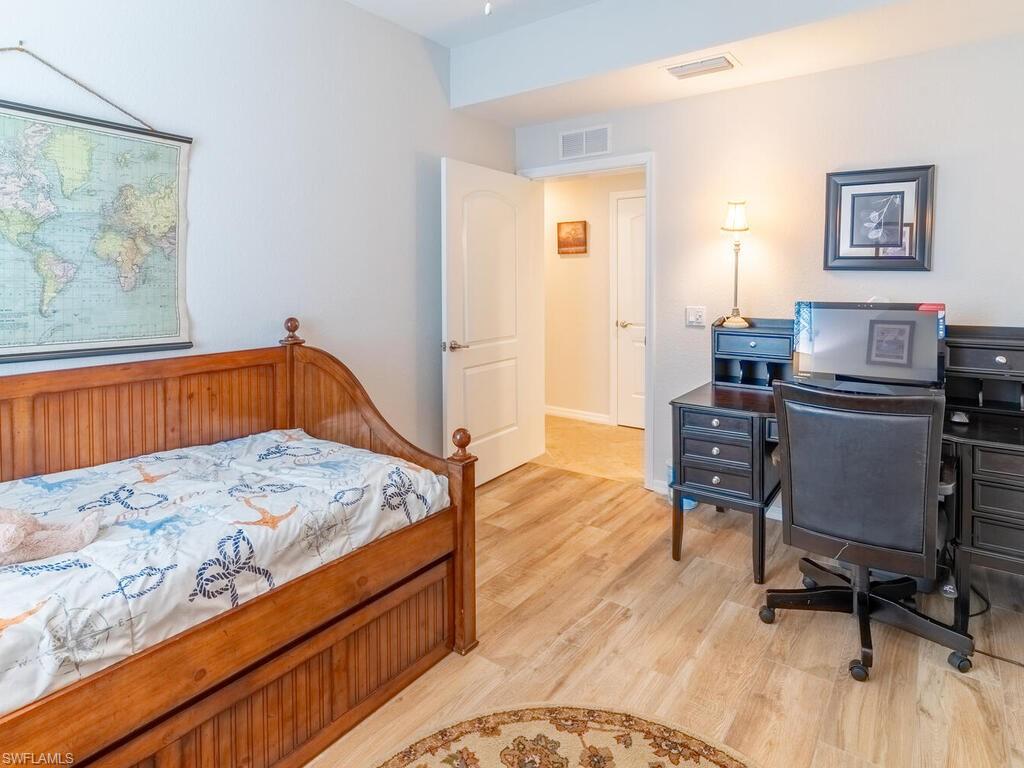 9115 Napoli Court, Unit 101 Naples, FL 34113 - Photo 22 of 49 a bedroom with a bed and furniture