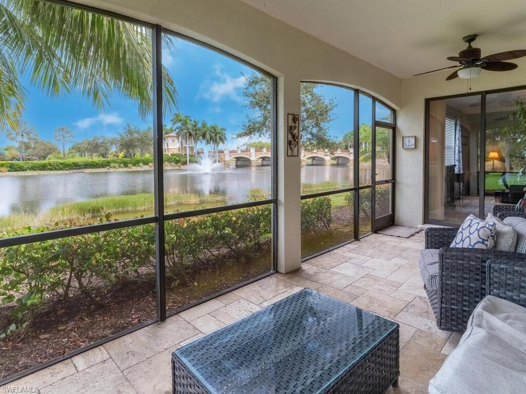 9115 Napoli Court, Unit 101 Naples, FL 34113 - Photo 24 of 49 a bedroom with a bed and glass window