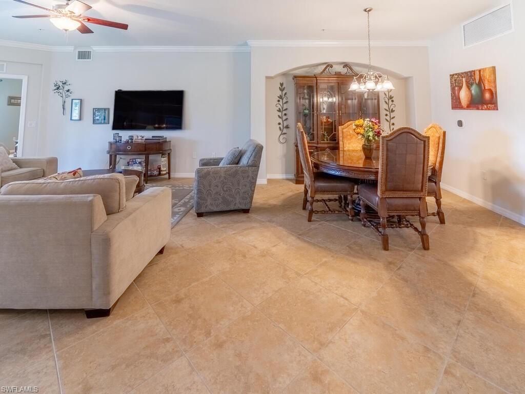 9115 Napoli Court, Unit 101 Naples, FL 34113 - Photo 5 of 49 a living room with furniture and a flat screen tv