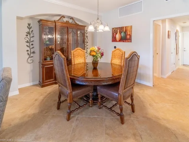 a dining room with furniture and chandelier or bathroom